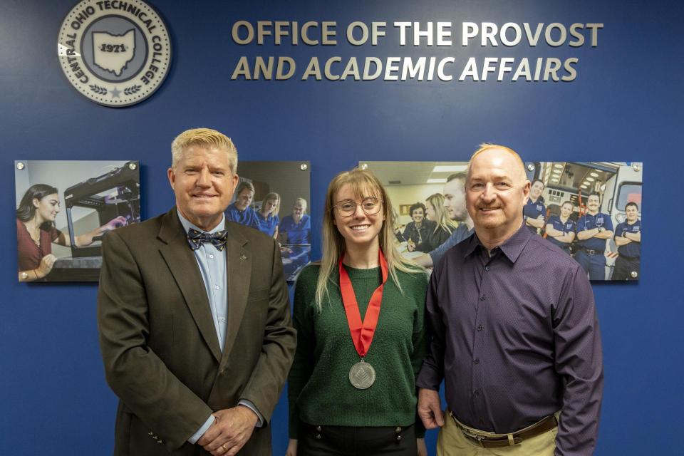 President John M. Berry, PhD; Cassie Summers; Provost Gregory Ferenchak, EdD Cassie Summer wears her League Excellence Award medal while standing between COTC Provost Gregory Ferenchak and COTC President John Berry.