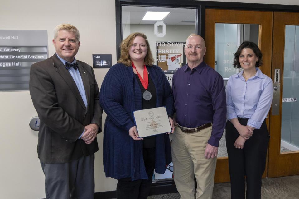 President John M. Berry, PhD; Rachel Brandenburg; Provost Gregory Ferenchak, Ed; Ashton Lahman Rachel Brandenburg holds her League Excellence Award certificate while standing between COTC Provost Gregory Ferenchak, COTC President John Berry and Director of Marketing and Public Relations Ashton Lahman.