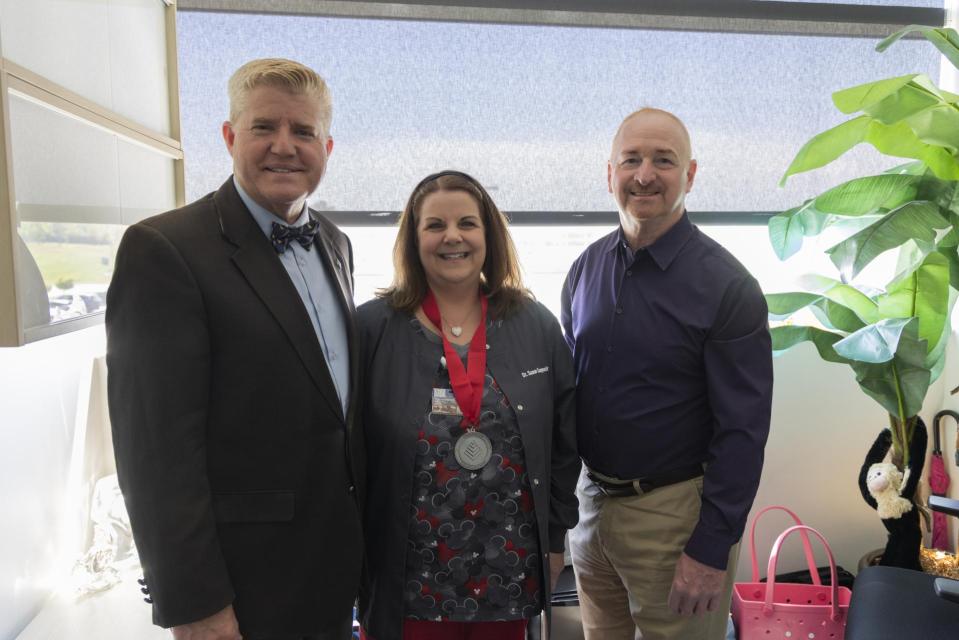 President John M. Berry, PhD; Susan Cooperider, EdD; Provost Gregory Ferenchak, EdD Susan Cooperider wears her League Excellence Award medal while standing between COTC Provost Gregory Ferenchak and COTC President John Berry.