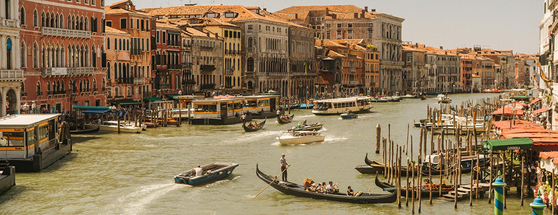 Gondolas in a canal in Italy. 