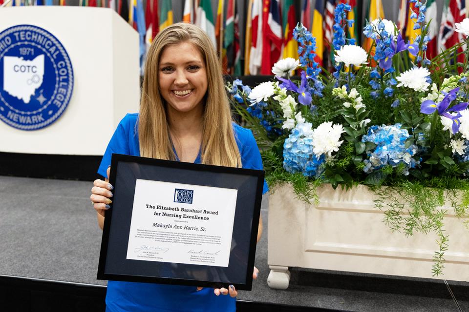 Makayla Ann Harris holds her award during the nursing pinning ceremony.