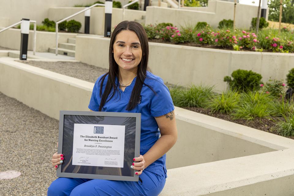 COTC graduate Brooklyn Pennington poses with her plaque for the Elizabeth Barnhart Award in Spring 2024 on the Newark Campus.
