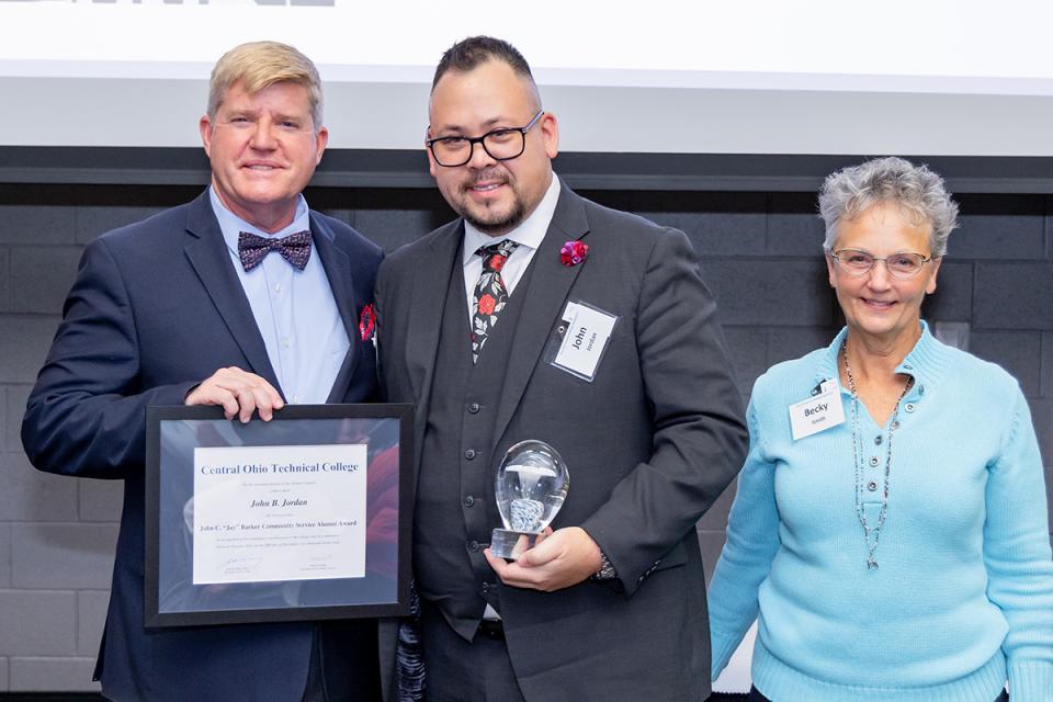 John B. Jordan stands with COTC President John Berry and COTC Alumni Council President Becky Smith after receiving the Barker Community Service Alumni Award.