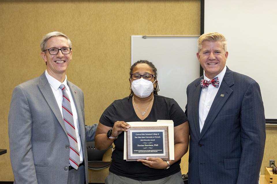 Diversity Award recipient Dorian Harrison with her award plaque stands between Ohio State Newark Dean and Director Matthew Smith and COTC President John Berry.