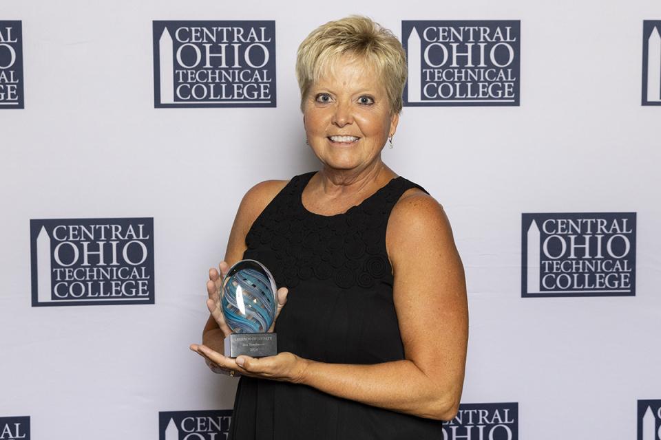 Portrait of Jan Tomlinson with her Legend of Loyalty award.