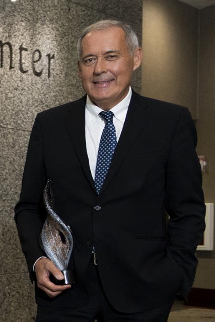 Andrea Tozzi holds his Legends of Loyalty award trophy.