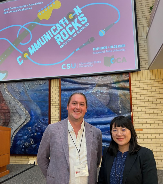 James Jarc and Sharon Chuang stand in a conference room at the Ohio Communication Association annual conference.