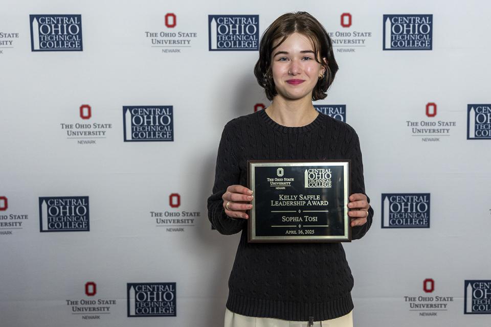 Sophia Tosi, Kelly Saffle Leadership Award recipient Portrait of Sophia Tosi holding their award plaque.