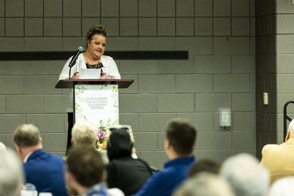 Megan Connell-Cox, COTC human services alumna and disabled veteran, established the Empower, Inspire and Impact Scholarship for COTC students. Megan Connell-Cox stands at a podium delivering a speech.