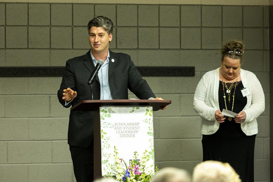 Trace Johnson, a former engineering student at COTC and Ohio State Newark, established the Tony Maric Mathematics Scholarship for students at both schools in memory of his friend and former math tutor. Trace Johnson stands at a podium delivering a speech.
