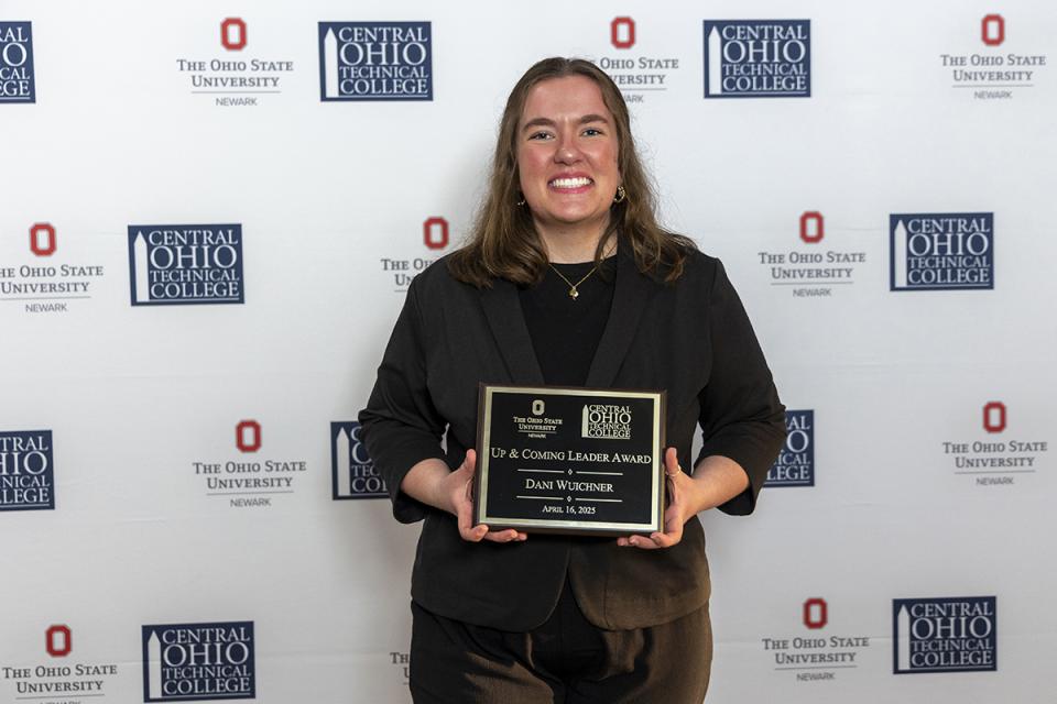 Dani Wuichner, Up and Coming Leader Award recipient Portrait of Dani Wuichner holding their award plaque.