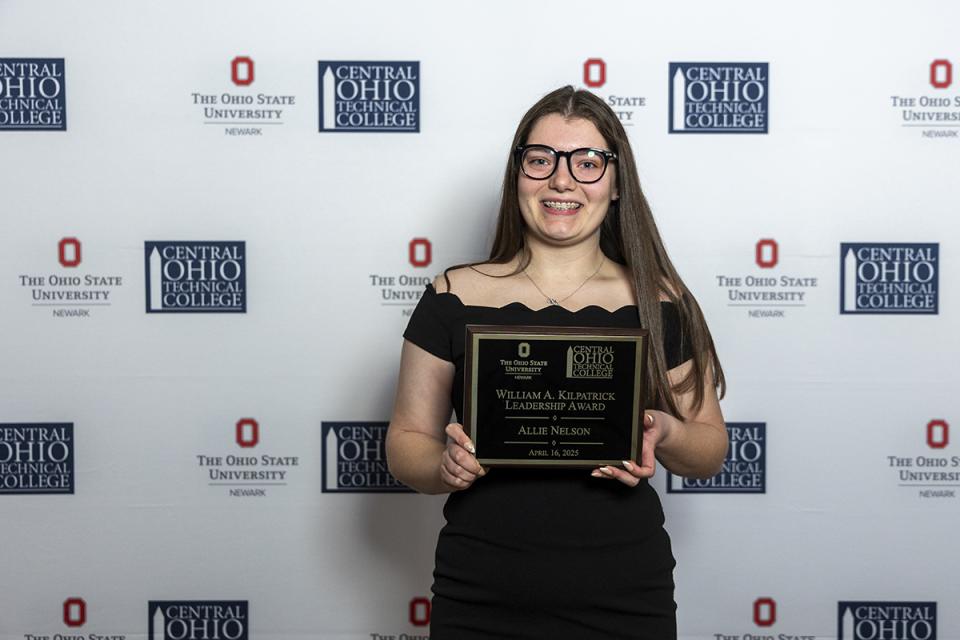 Allie Nelson, William A. Kilpatrick Leadership Award recipient Portrait of Allie Nelson holding their award plaque.