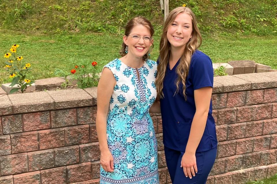 Becca Saxton (right) and her mom. Becca Saxton stands wither her mom on the day of her pinning ceremony at COTC.