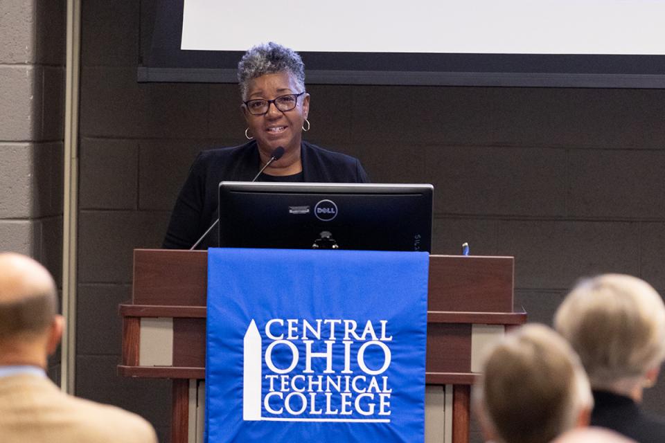 Vorley Taylor stands at a podium speaking at the Legacy and Leadership Dinner in 2023.