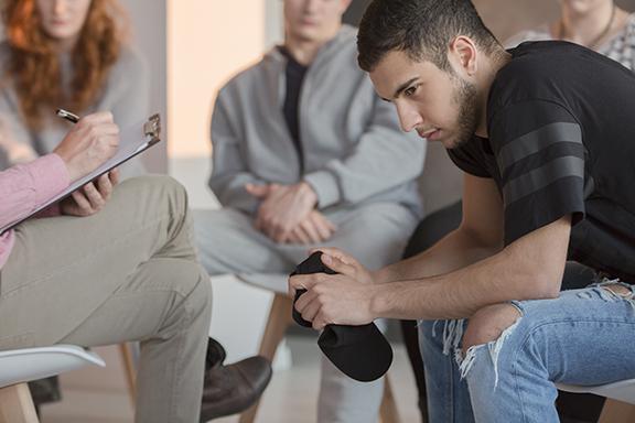 Shot of a man in a chair answering interview questions