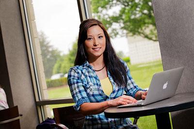 COTC Student working on a laptop