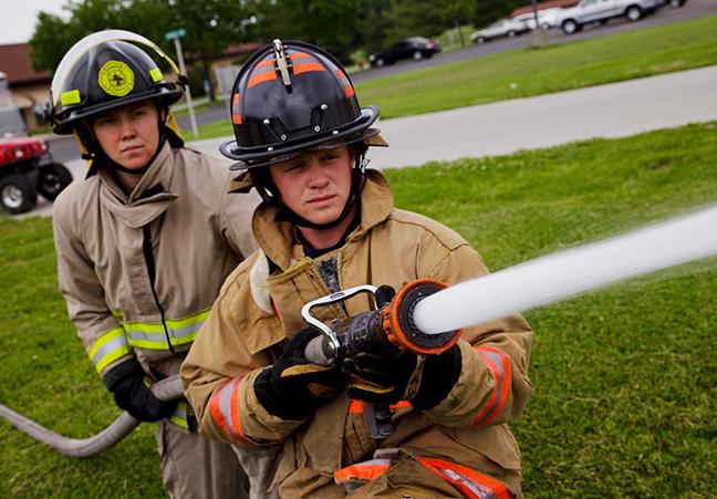 Firemen holding a firehose