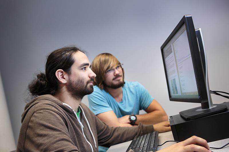 Two Students working on a computer