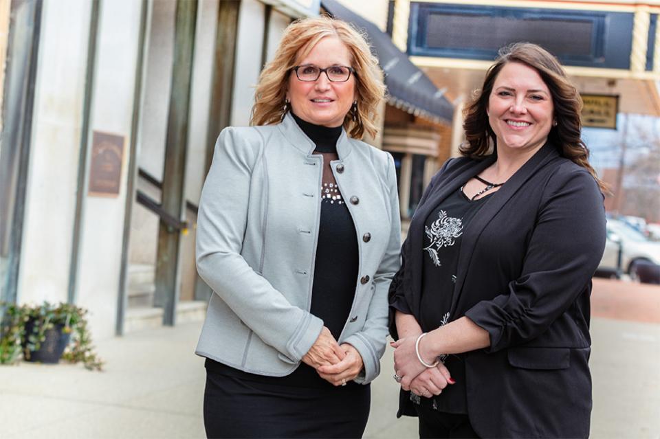 Jennifer McDonald and Brittany Misner stand next to each other outside local businesses  in downtown Newark.