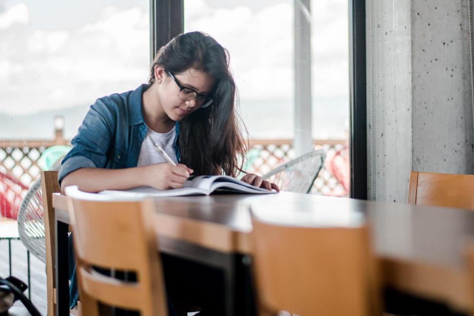 Girl sitting at table studying