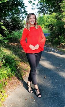 Sydney Palur on outdoor path wearing red shirt and jeans