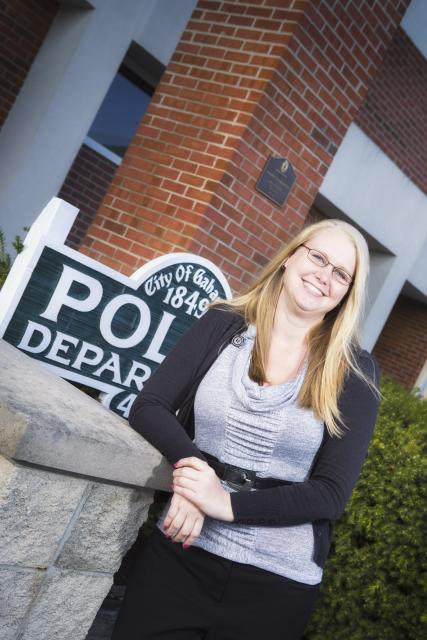 Picture of woman posing outside the police department