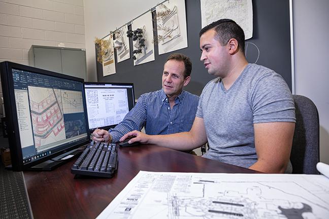 Faculty member with student in front of a computer